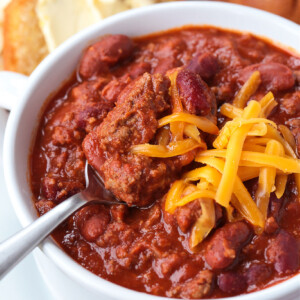 beef chili in white bowl with spoon