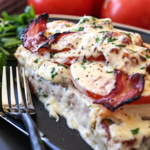 kentucky hot brown sandwich on black plate with forks