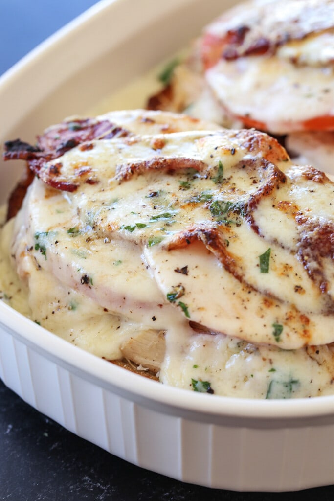A Kentucky Hot Brown Sandwich is a delicious way to use leftover turkey. Baked with slices of tomato and bacon smothered in a cheesy sauce! baked Kentucky Hot Brown Sandwich in baking dish