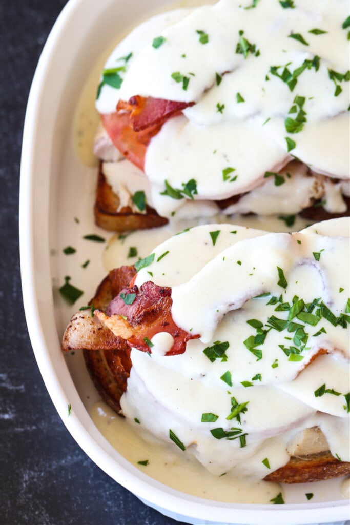 Mornay sauce spooned over open face turkey sandwiches