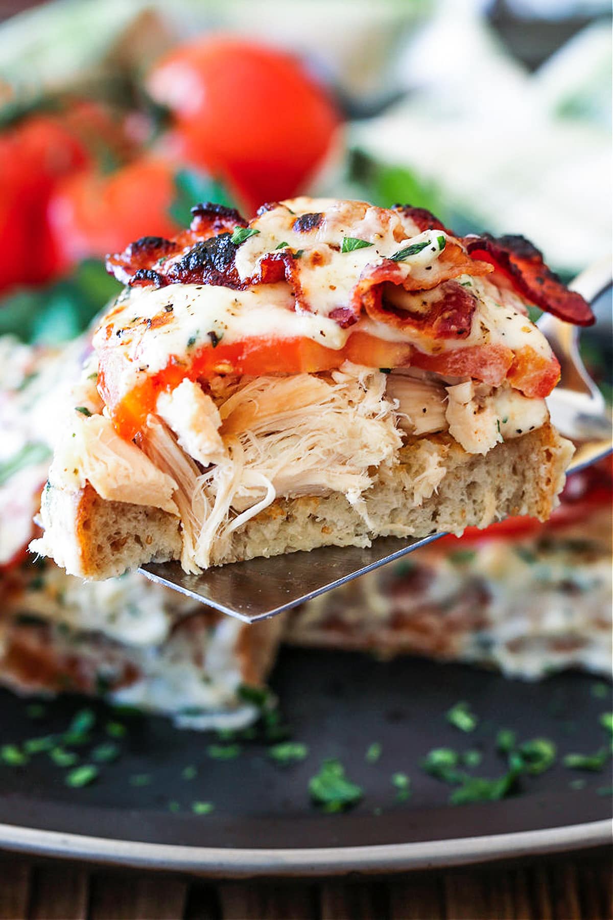 A Kentucky Hot Brown Sandwich is a delicious way to use leftover turkey. Baked with slices of tomato and bacon smothered in a cheesy sauce! A Kentucky Hot Brown sliced and served on a spatula