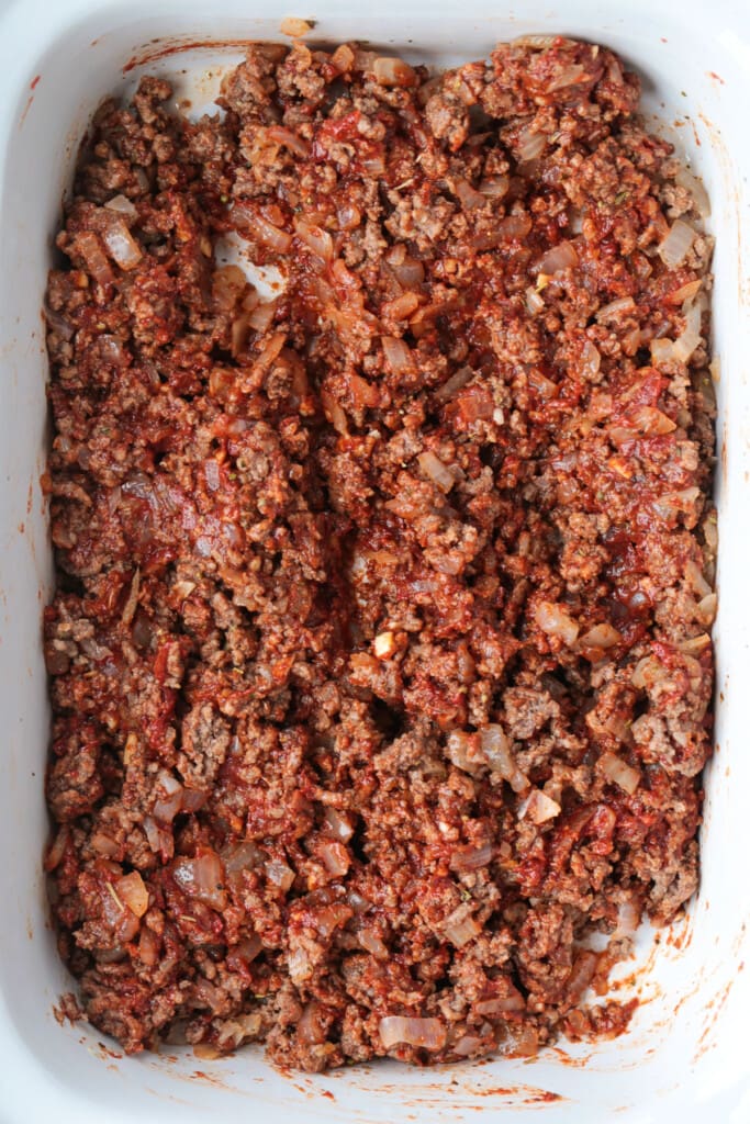 cooked ground beef mixed with tomato paste, onions and garlic