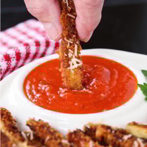 eggplant fry dipping into marinara sauce