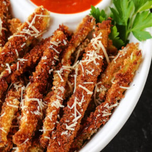 eggplant fries in a bowl with parmesan cheese and sauce