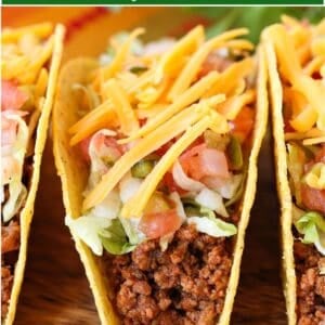 tacos lined up on board with text overlay for pinterest