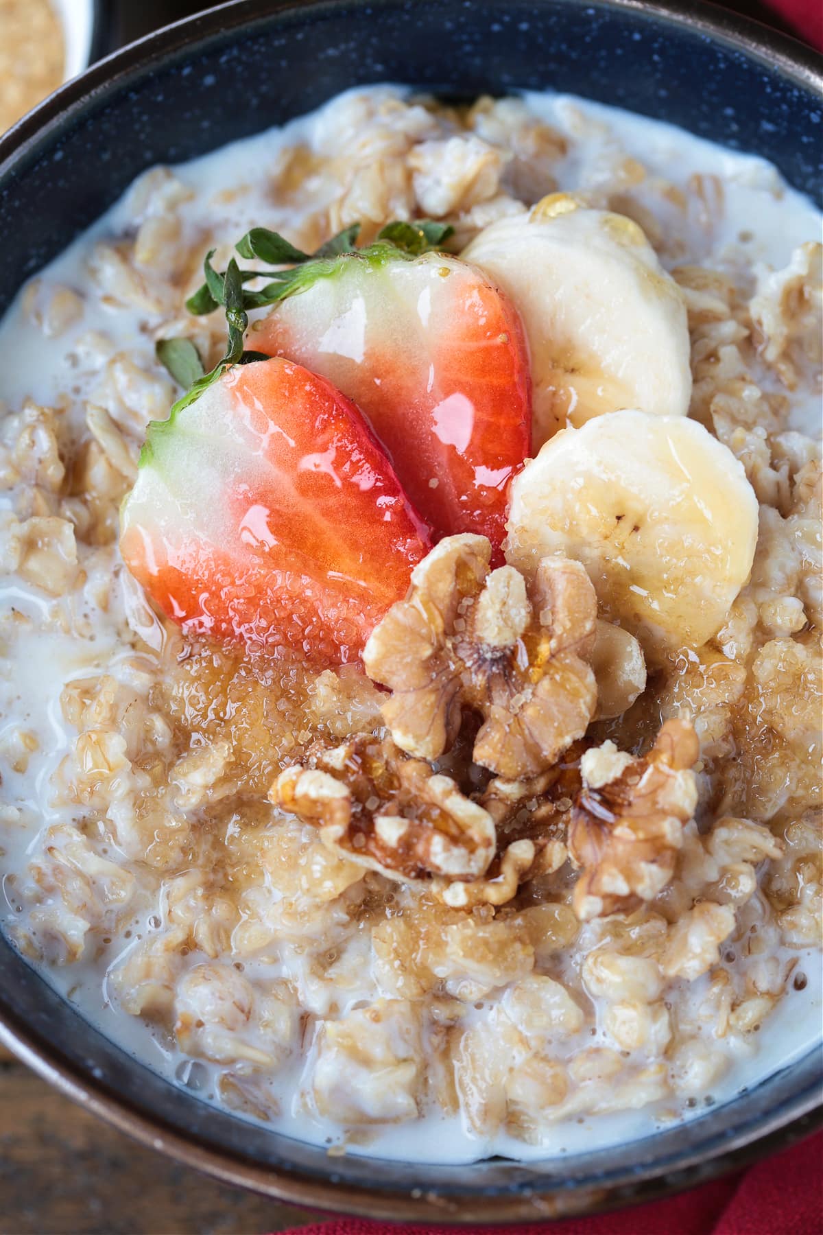 oatmeal in a bowl with strawberries, bananas and walnuts