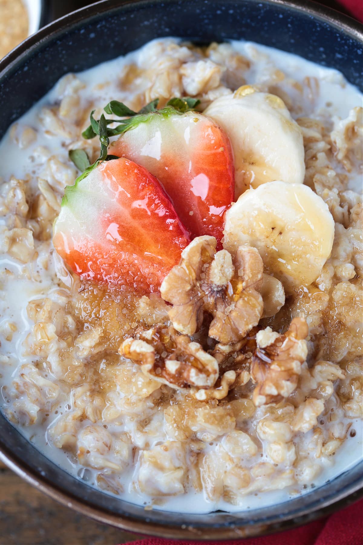 How To Make Oatmeal In The Microwave for the best flavor and texture. A hearty, delicious breakfast that's ready to go in just 5 minutes. oatmeal in a bowl with strawberries, bananas and walnuts
