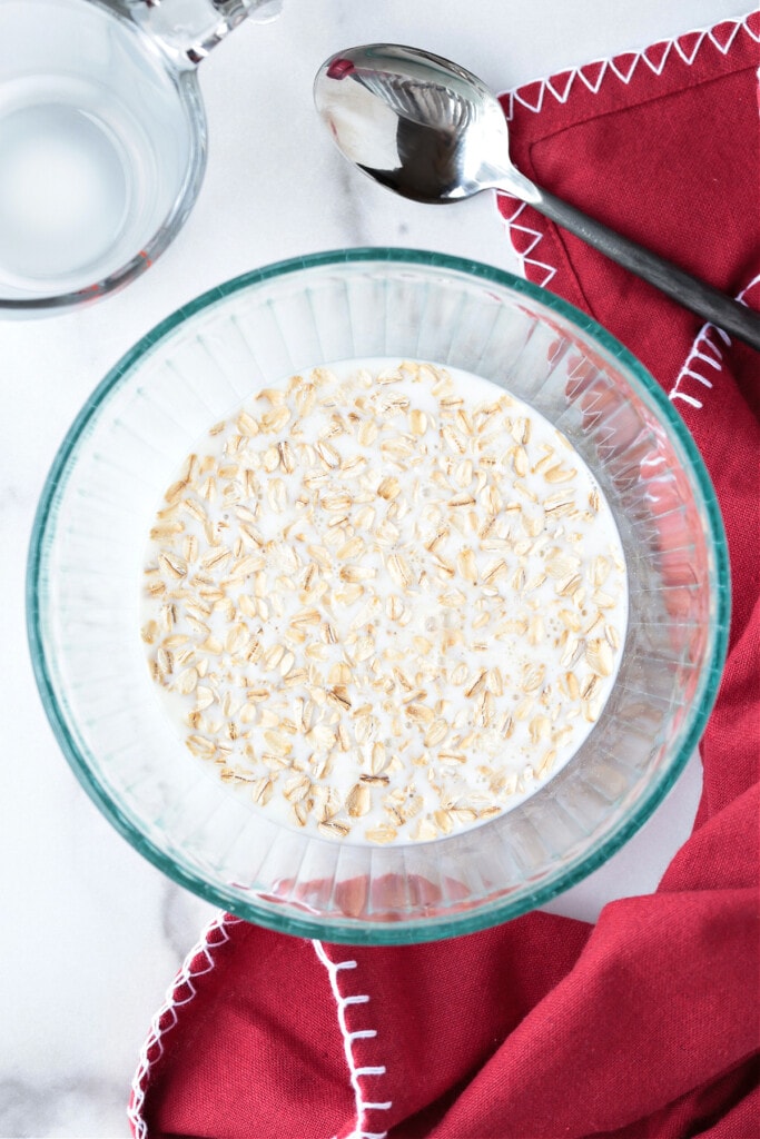 How To Make Oatmeal In The Microwave for the best flavor and texture. A hearty, delicious breakfast that's ready to go in just 5 minutes. oats and milk in a bowl for making microwave oatmeal