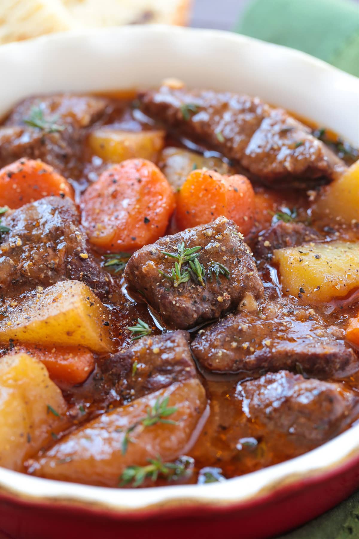 This Irish Stew Recipe is packed with tender beef and vegetables, simmered in a beer and wine gravy. A comfort food dinner all in one pot! Irish stew in a bowl from the side