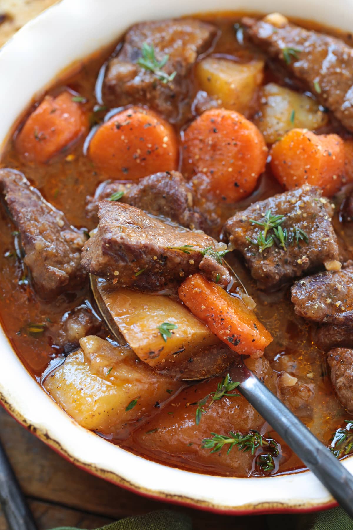This Irish Stew Recipe is packed with tender beef and vegetables, simmered in a beer and wine gravy. A comfort food dinner all in one pot! beef stew in bowl with spoon