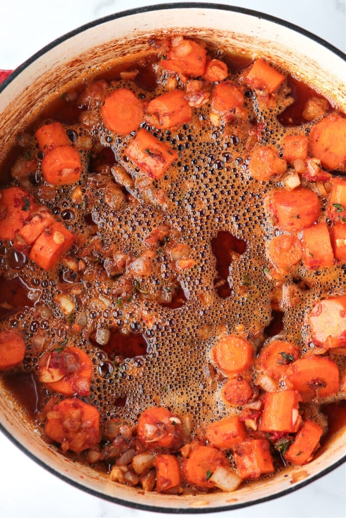 This Irish Stew Recipe is packed with tender beef and vegetables, simmered in a beer and wine gravy. A comfort food dinner all in one pot! Beer in a pot with stew to make gravy