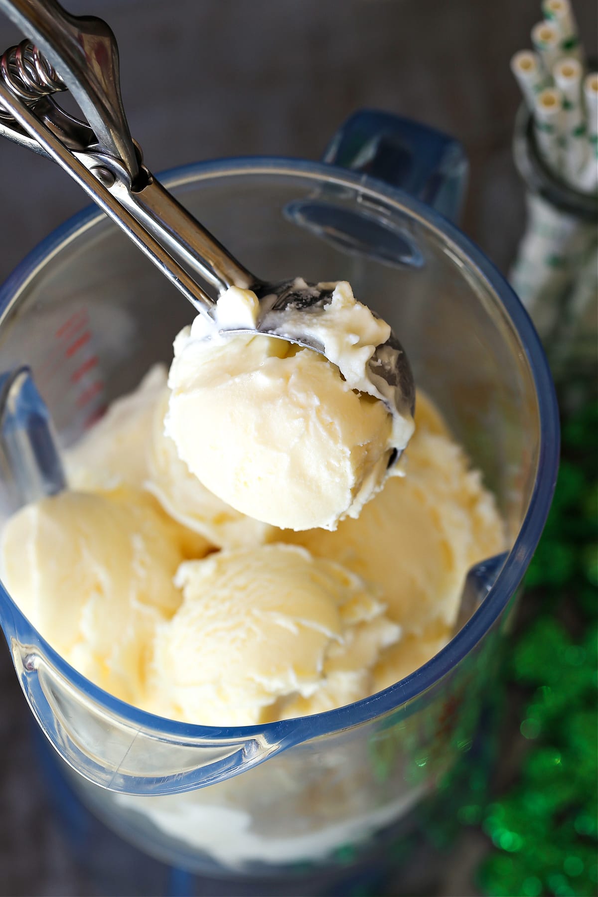 vanilla ice cream being scooped into a blender