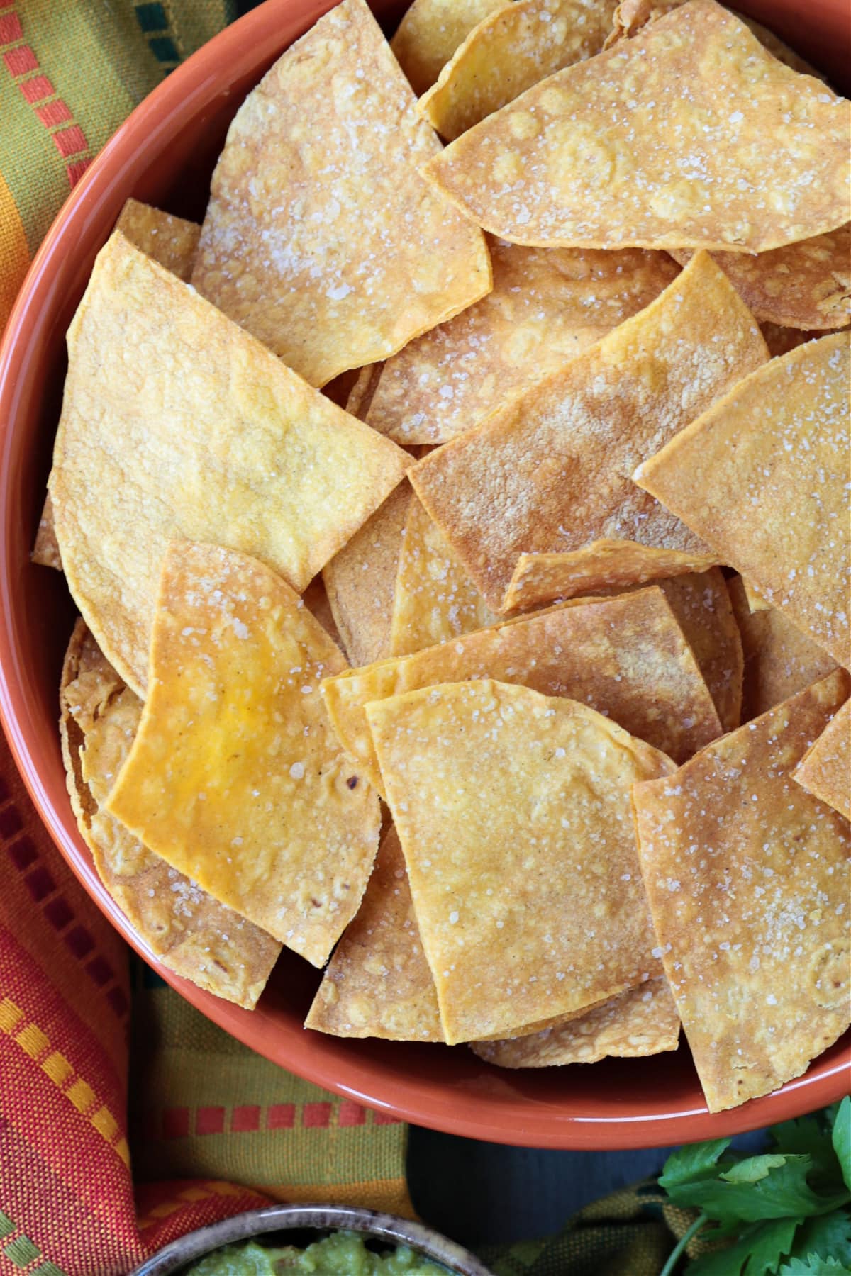 These Air Fryer Tortilla Chips are super crispy and so addicting! Dip them in salsa, serve them with soups or make a platter of nachos! air fryer tortilla chips in large bowl