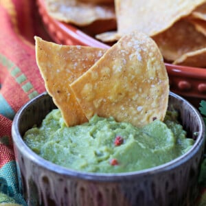 tortilla chips dipped into guacamole