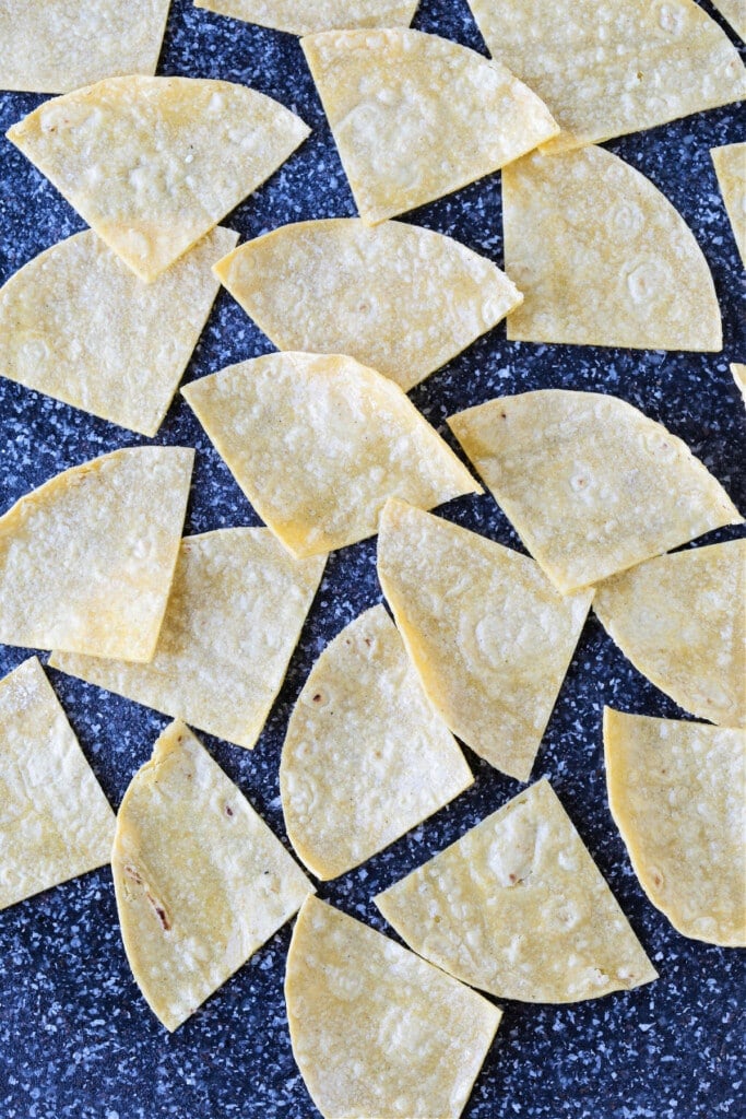 These Air Fryer Tortilla Chips are super crispy and so addicting! Dip them in salsa, serve them with soups or make a platter of nachos! corn tortillas cut into wedges for making chips