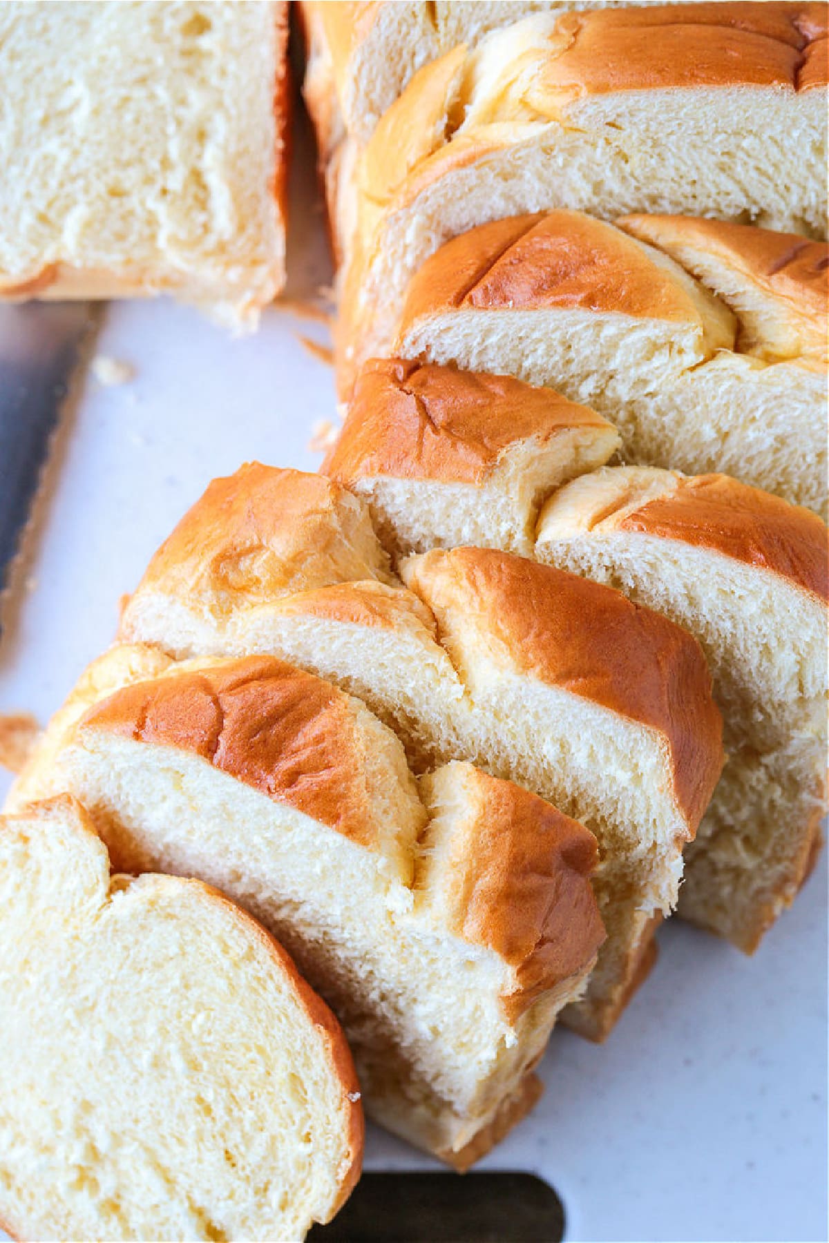 Sliced brioche bread on a board for bread pudding recipe