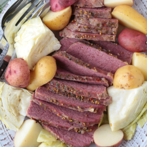 corned beef, cabbage and potatoes sliced on a white platter