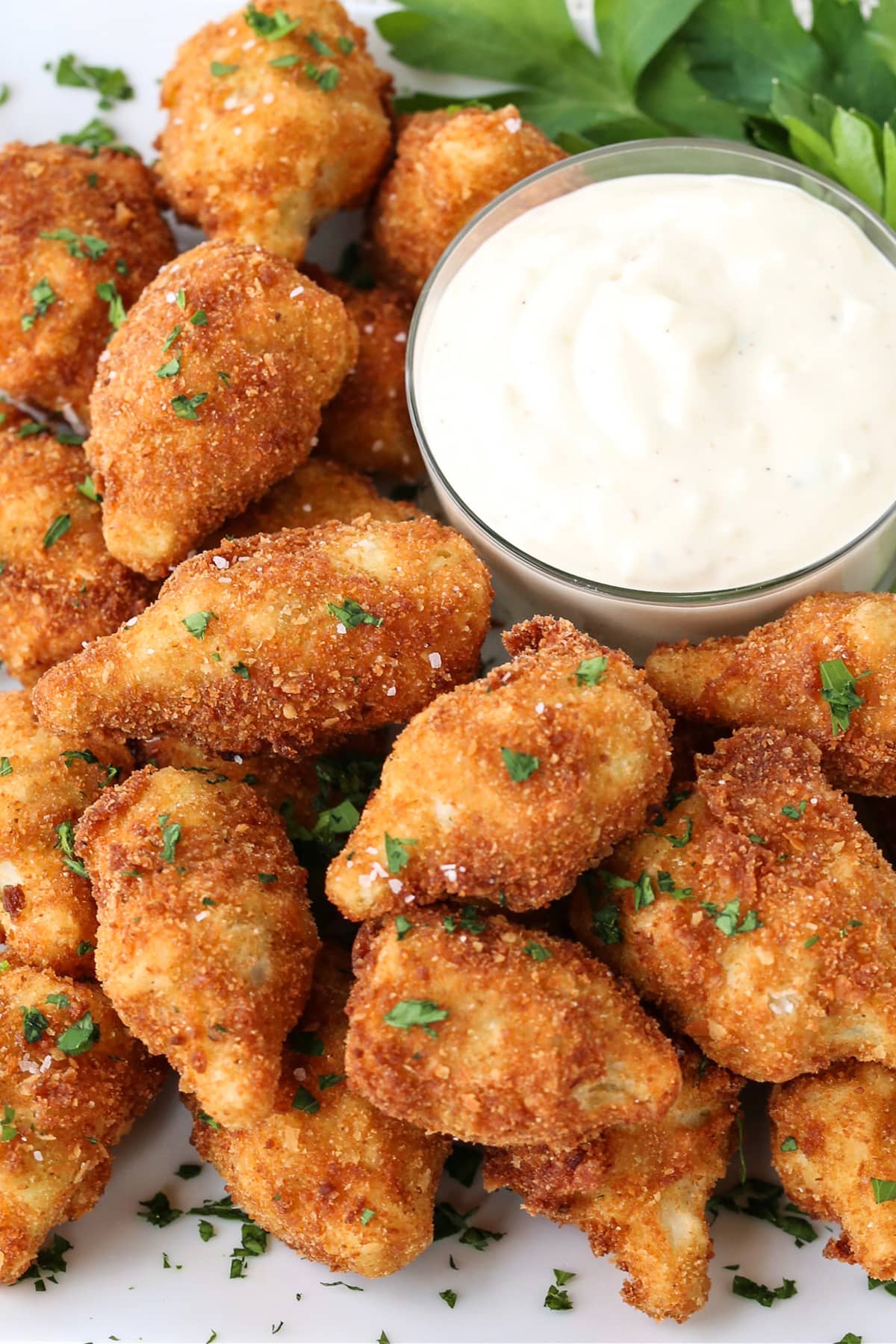 These Fried artichoke hearts are a crispy and addicting appetizer! Make our easy roasted garlic aioli to serve alongside for dipping! fried artichoke hearts on a plate with aioli