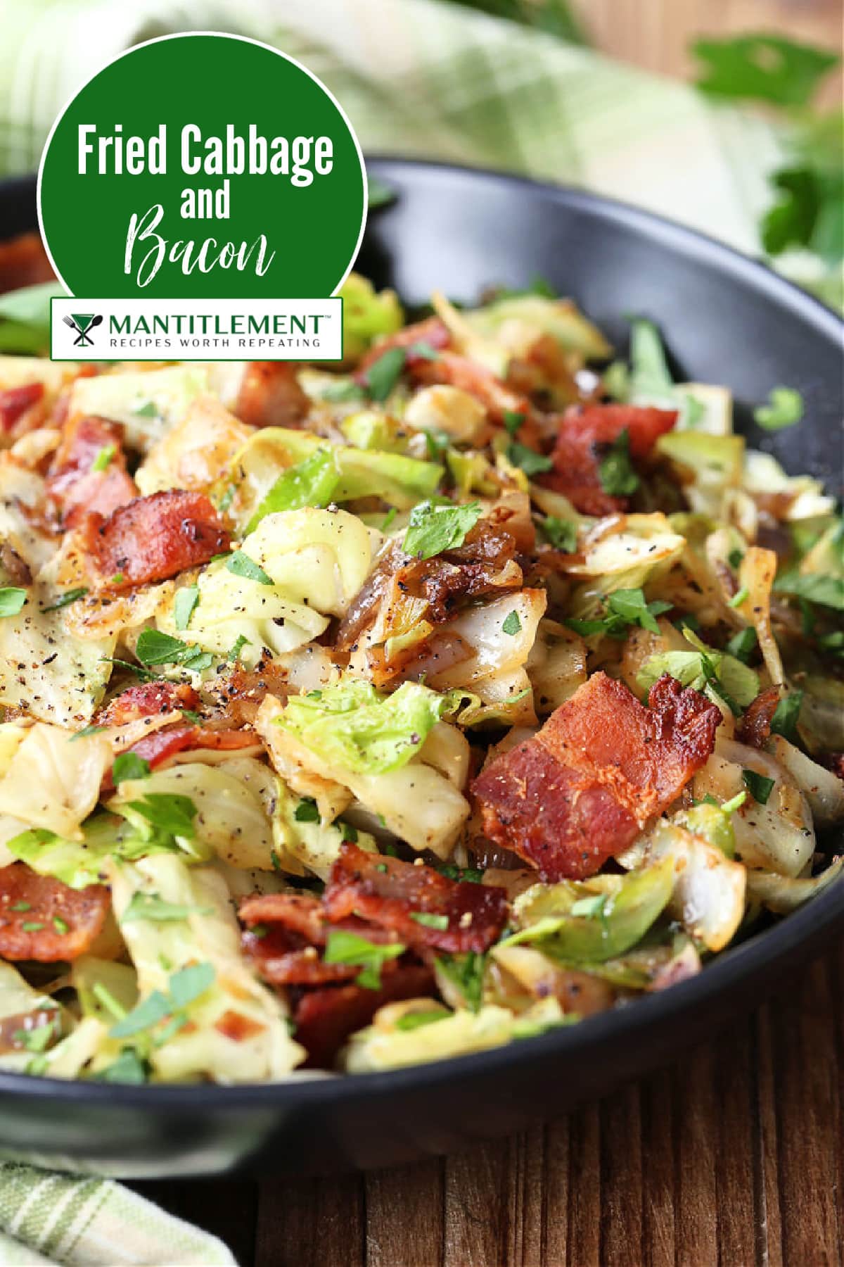 fried cabbage with bacon in black bowl with text for pinterest
