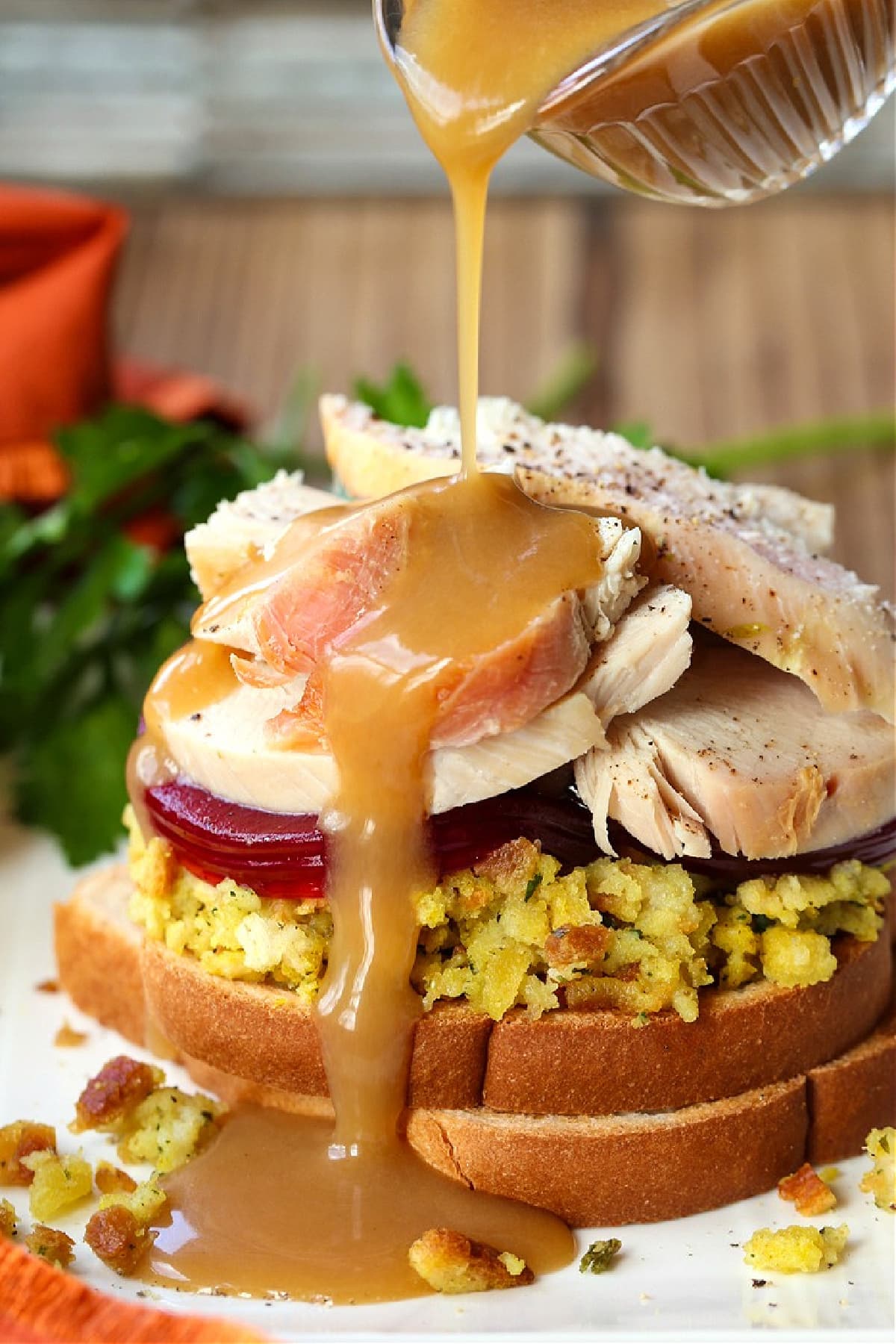 Make a Hot Turkey Sandwich with your leftover turkey! This tasty, open faced sandwich is our favorite way to use up Thanksgiving leftovers! gravy pouring on a turkey sandwich