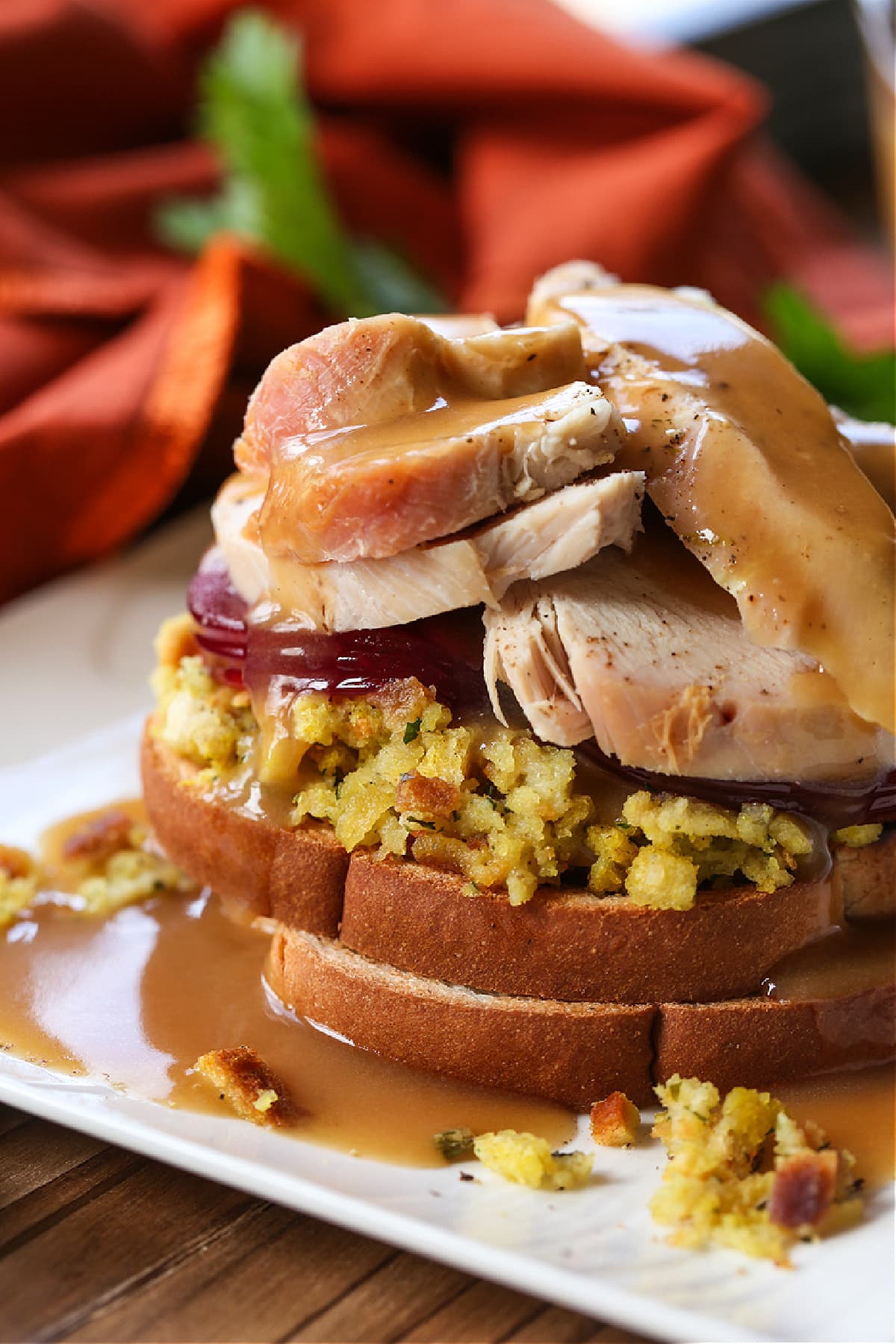 Make a Hot Turkey Sandwich with your leftover turkey! This tasty, open faced sandwich is our favorite way to use up Thanksgiving leftovers! hot turkey sandwich on white plate with gravy