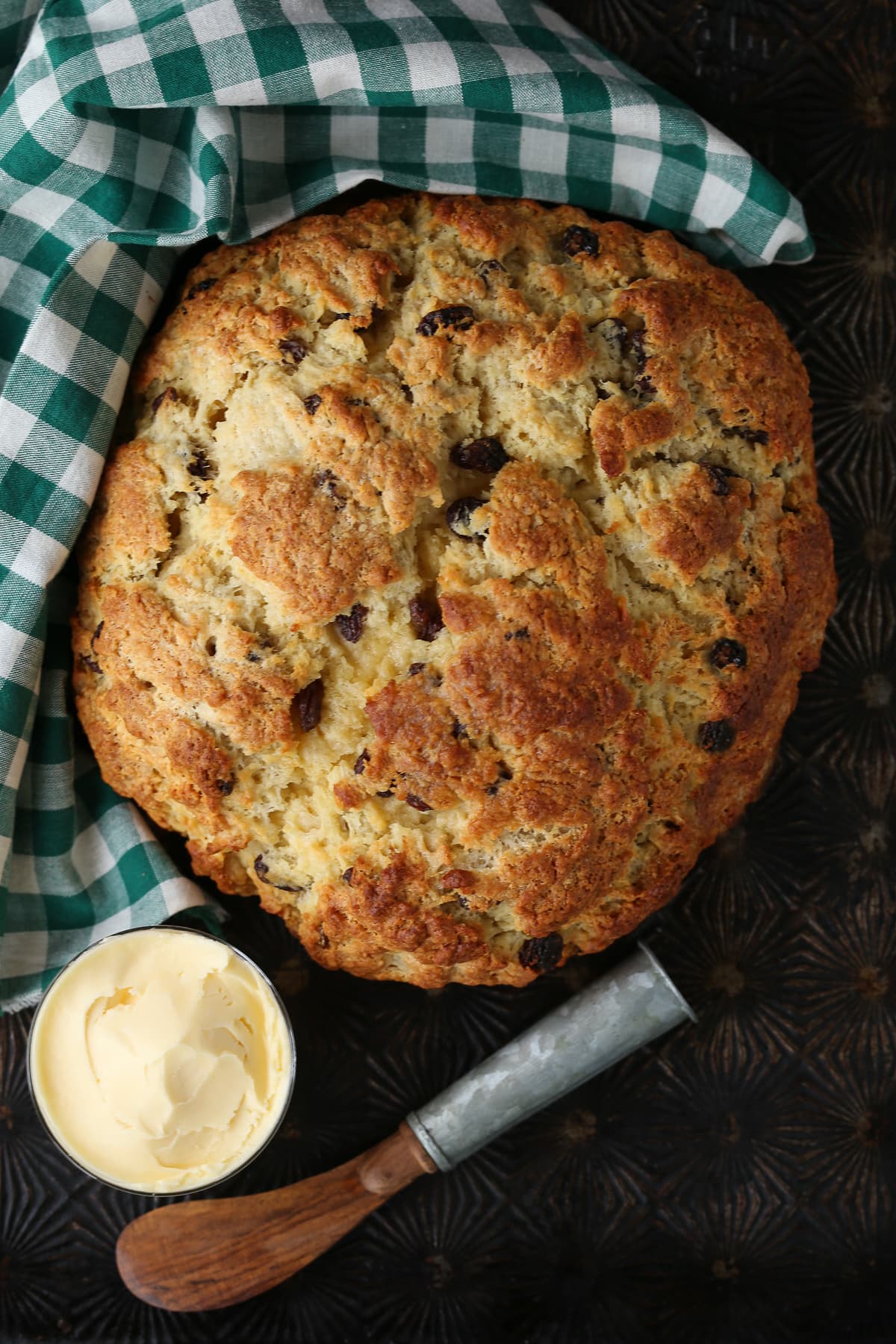 We love our slightly sweeter version of this classic Irish Soda Bread! Perfect for your St. Patrick's Day celebration, or as a homemade gift! Irish soda bread with green checkered napkin