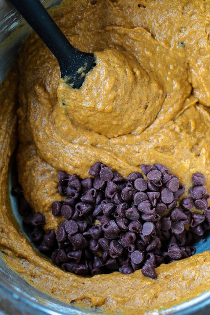 These Pumpkin Chocolate Chip Muffins are so moist and flavorful, made with real pumpkin puree. Enjoy them for breakfast, dessert or a snack! pumpkin muffin batter with chocolate chips