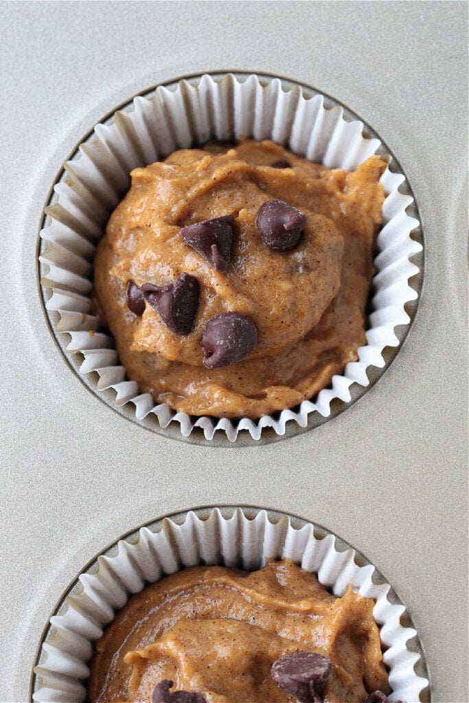 These Pumpkin Chocolate Chip Muffins are so moist and flavorful, made with real pumpkin puree. Enjoy them for breakfast, dessert or a snack! batter in muffin cups for pumpkin chocolate chip muffins
