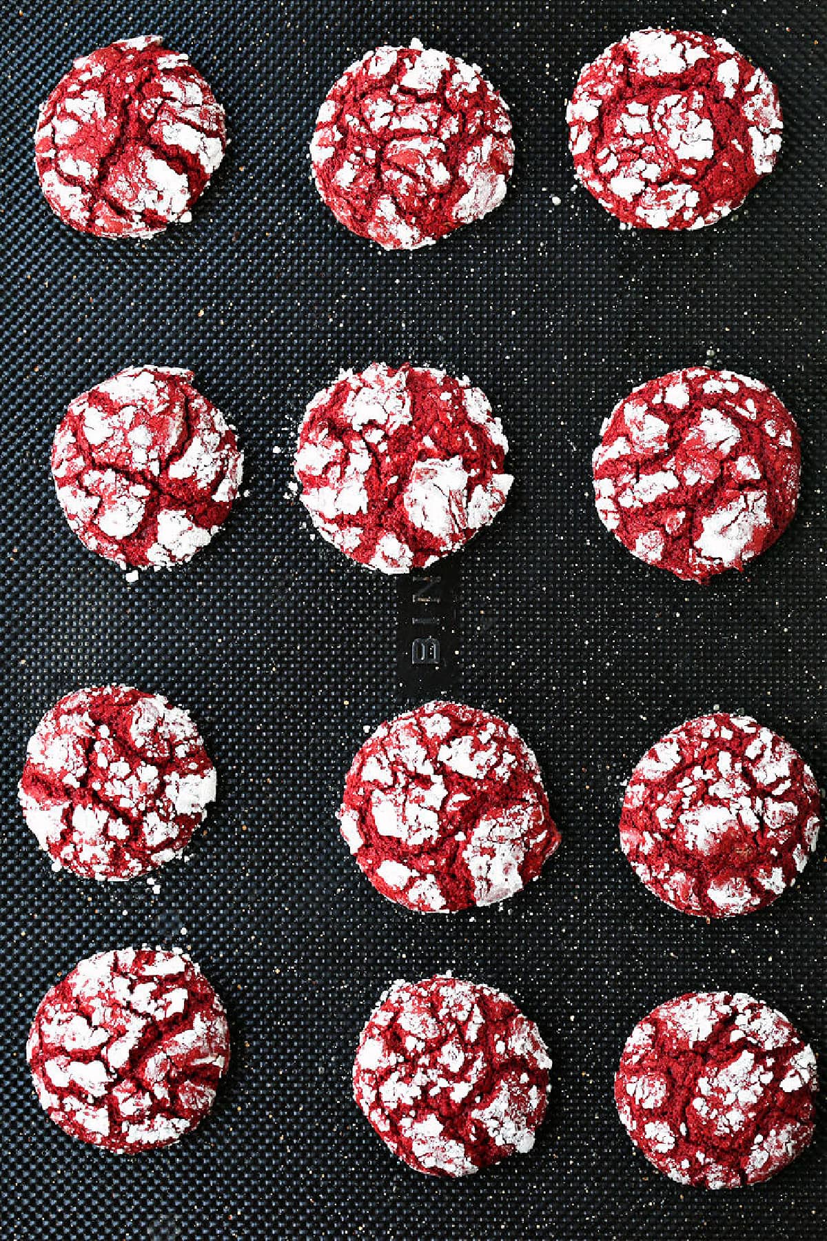 These Red Velvet Crinkle Cookies start off with your favorite boxed cake mix! Soft, cake-like cookies that are perfect for all occasions! red crinkle cookies on baking sheet