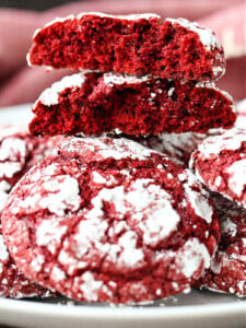 red velvet crinkle cookies stacked and broken in half