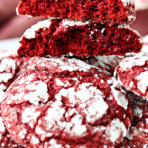 red velvet crinkle cookies stacked and broken in half