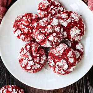 red velvet crinkle cookies on white plate with napkin