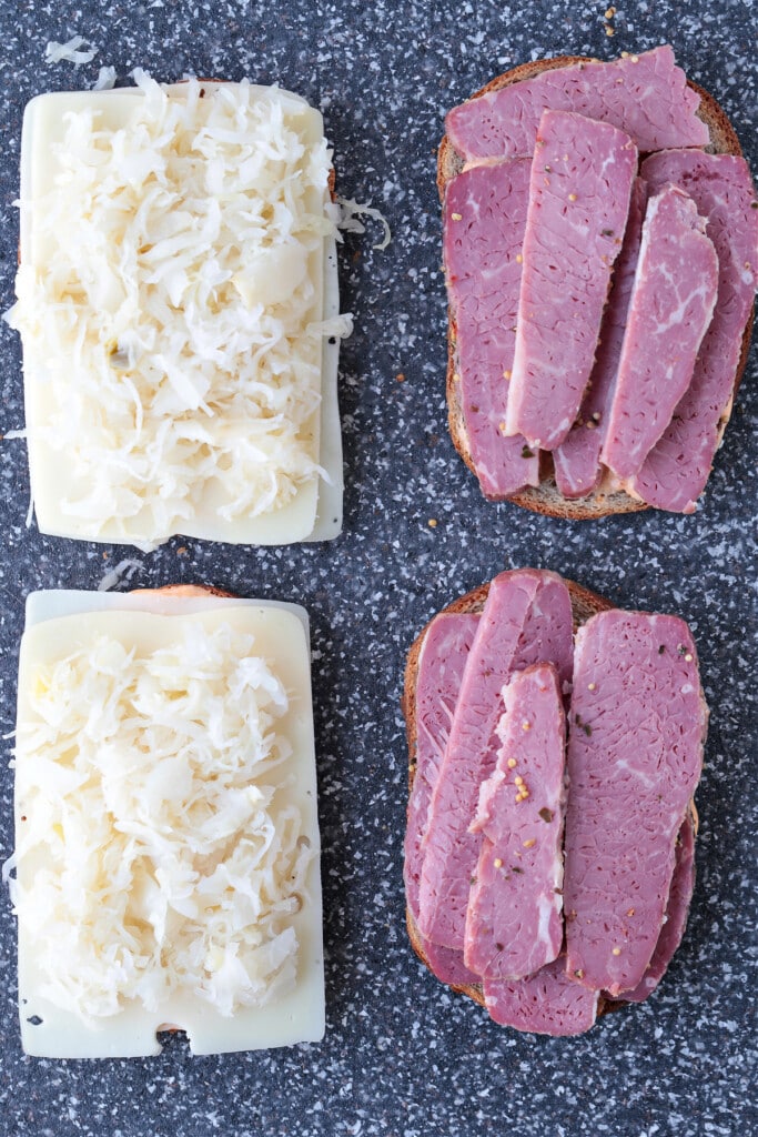 slices of rye bread with corned beef, cheese and sauerkraut