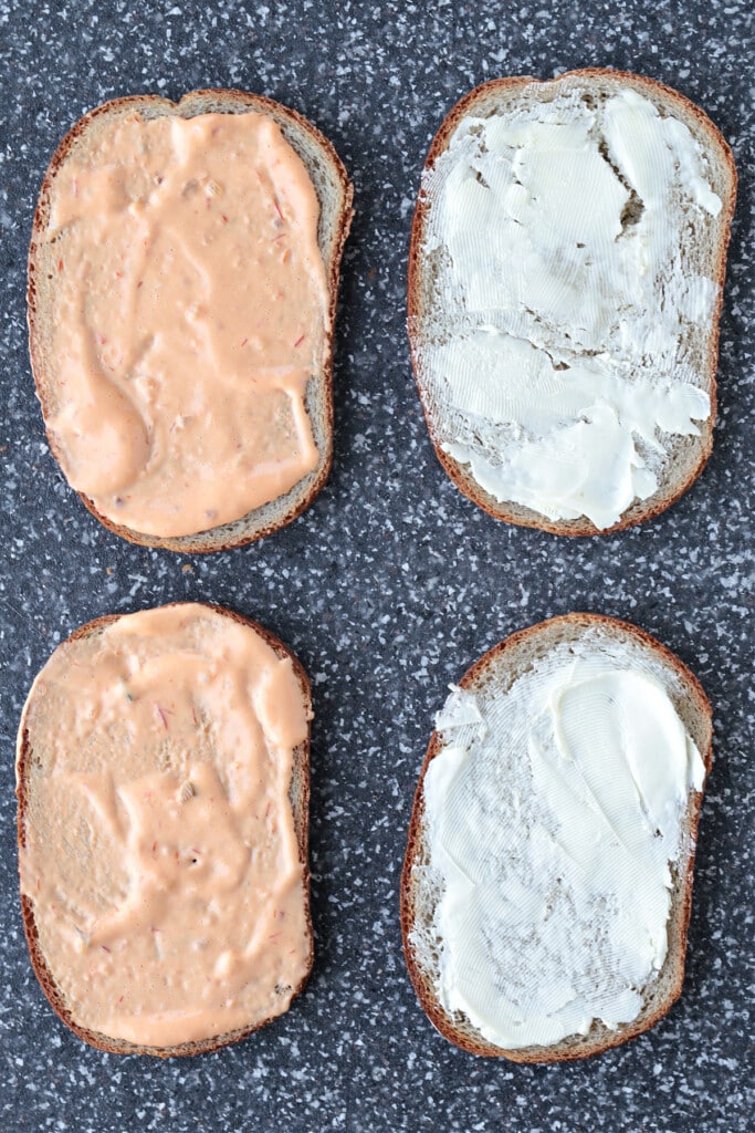 slices of rye bread on board with butter and Russian dressing