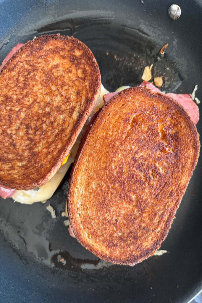 grilled reuben sandwiches in a skillet