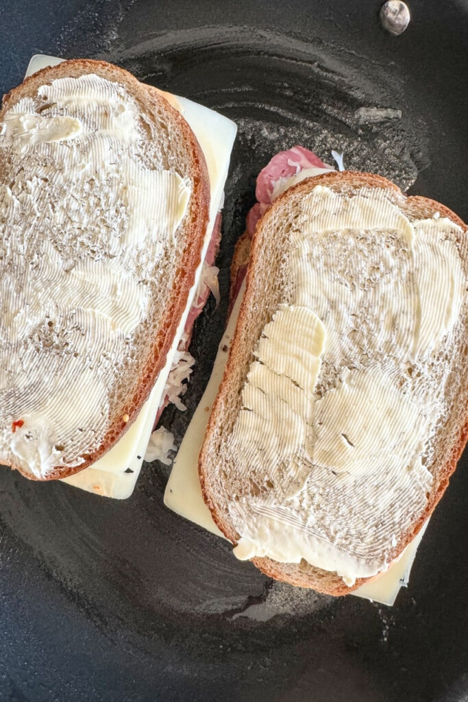 reuben sandwiches in a skillet with butter