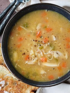 rotisserie chicken stock made into soup in black bowl