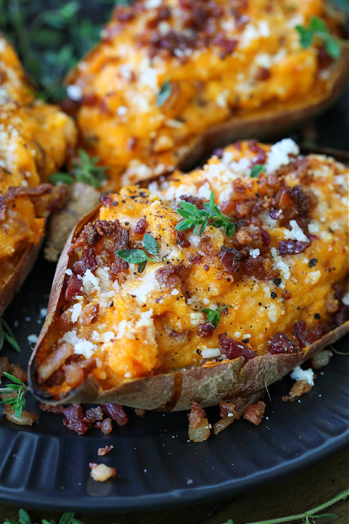 twice baked sweet potatoes garnished with parmesan cheese and thyme