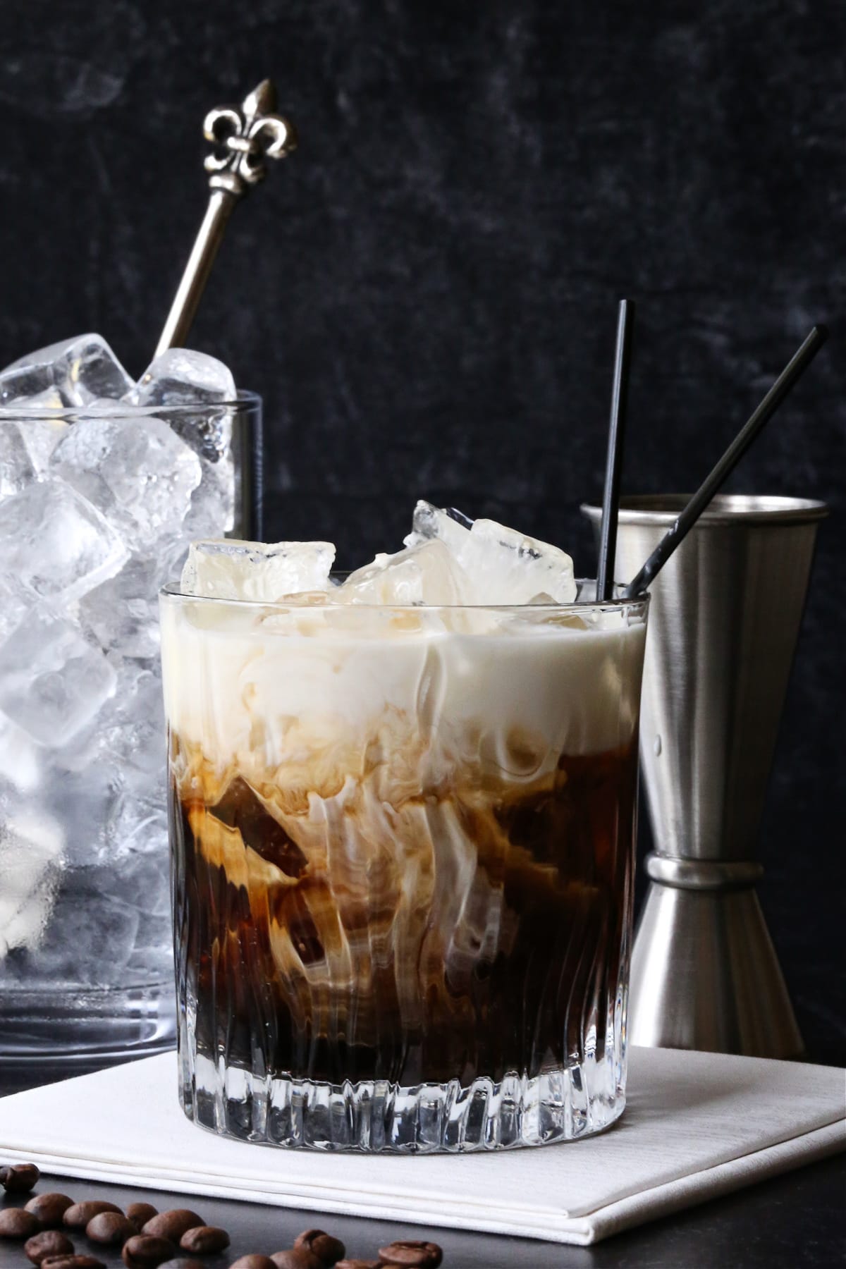 white russian cocktail with cream swirling in glass