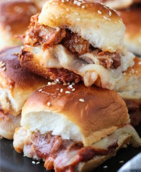 pork sliders stacked on plate with napkin
