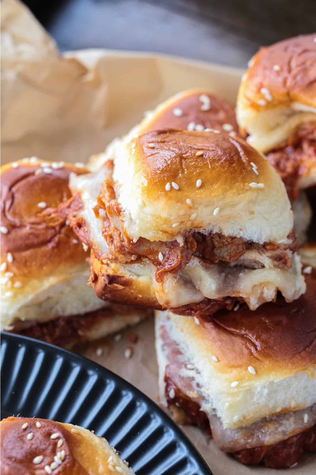 pulled pork sliders stacked on parchment