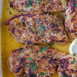 chicken breasts in a baking dish with greek marinade
