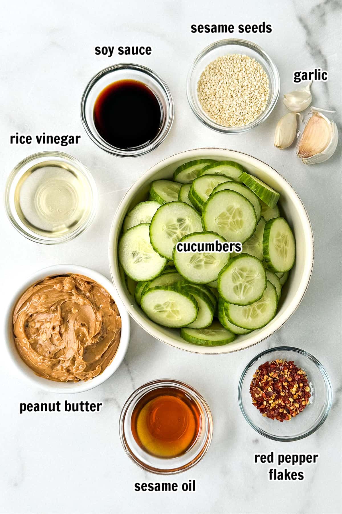 We're obsessed with this Asian Cucumber Salad! Crunchy cucumbers in a tangy, nutty sauce that's perfect as a side to dinner or on its own! ingredients for making asian cucumber salad