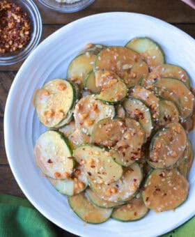 sliced cucumber salad in peanut sauce on plate
