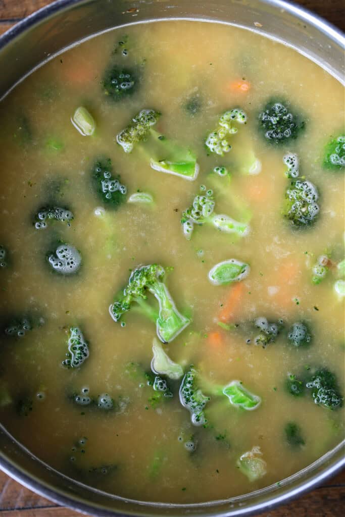 broccoli and carrots in soup pot with chicken broth