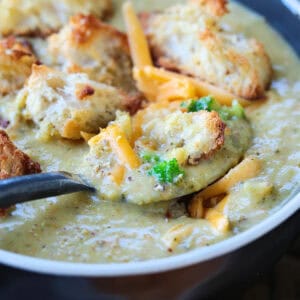 broccoli cheese soup with croutons in a bowl with spoon