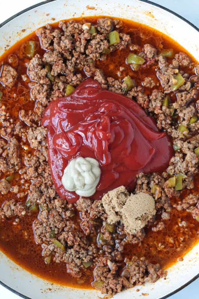 The best Homemade Sloppy Joes! Ground beef in a sweet and tangy sauce with green pepper and sweet onion. Ready in less than 30 minutes! sloppy joe meat in a skillet