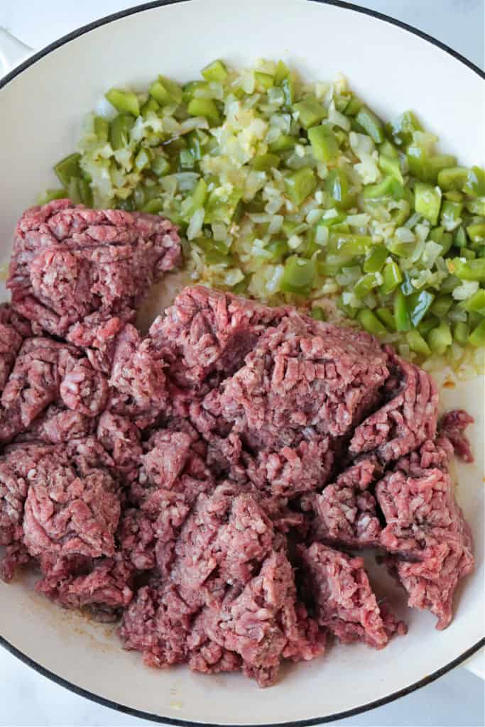 The best Homemade Sloppy Joes! Ground beef in a sweet and tangy sauce with green pepper and sweet onion. Ready in less than 30 minutes! ground beef in a skillet with green peppers and onions