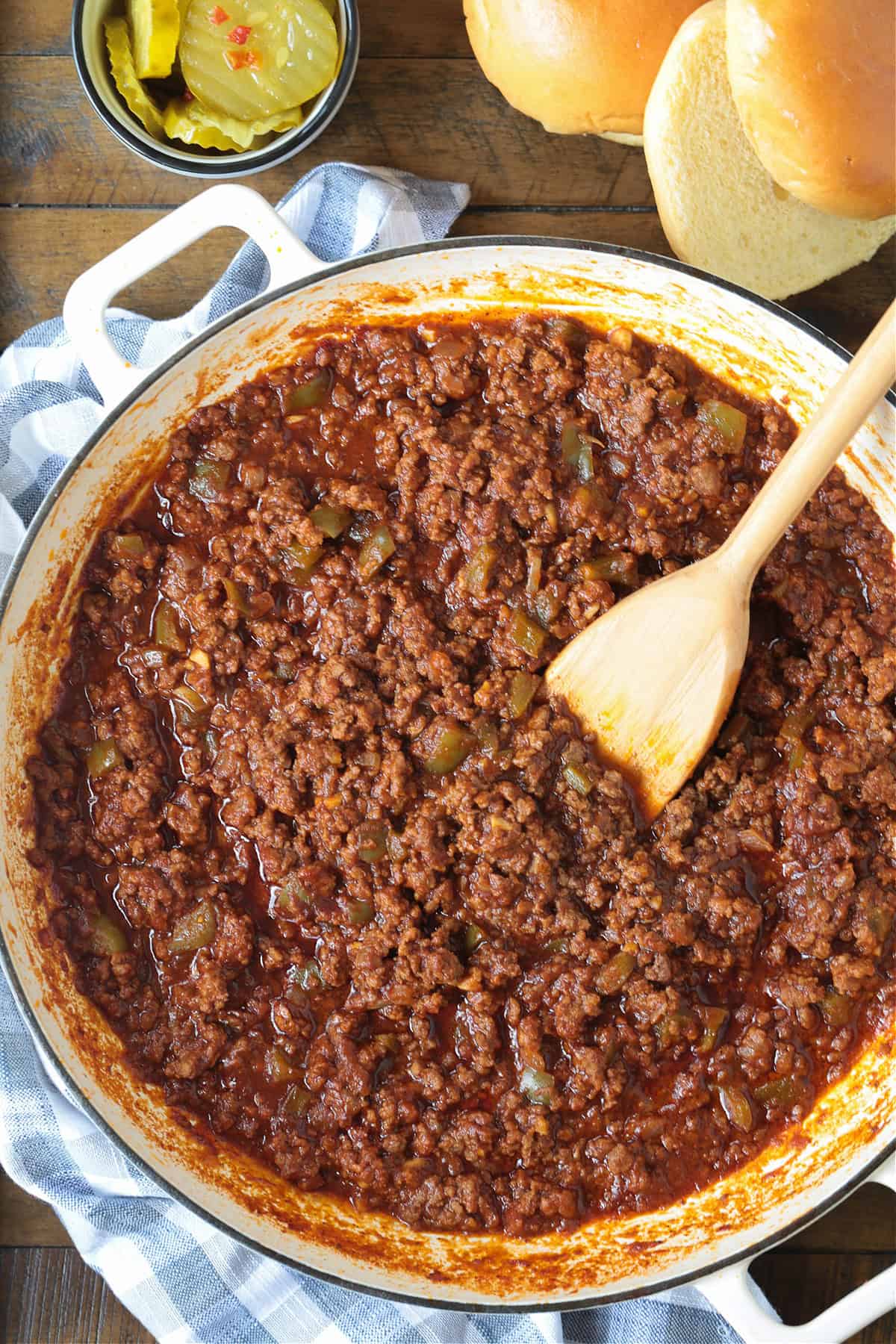 The best Homemade Sloppy Joes! Ground beef in a sweet and tangy sauce with green pepper and sweet onion. Ready in less than 30 minutes! sloppy joes in a skillet from the top with buns and pickles