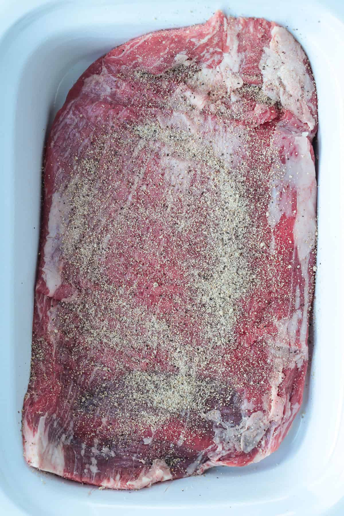 Slow Cooker Flank Steak is so tender and flavorful! When the grill isn't an option, try using a slow cooker to make your steak dinner. raw flank steak in slow cooker